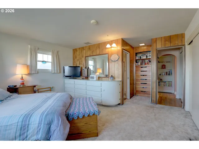 a bed room with a bed and a television