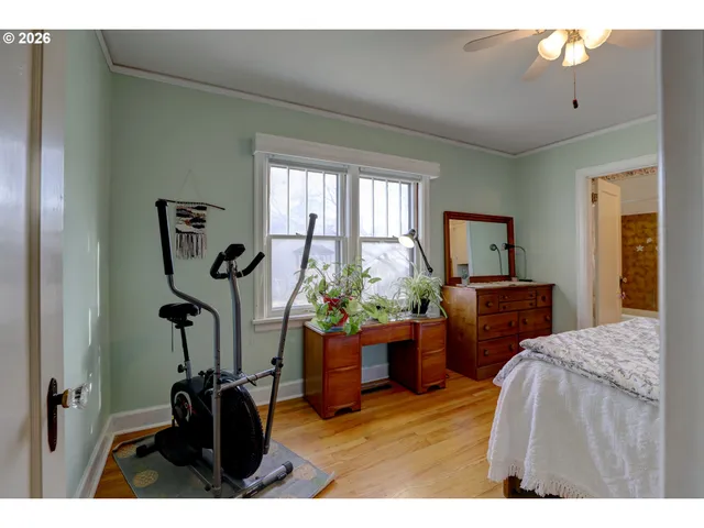 a living room with furniture a window and gym equipment