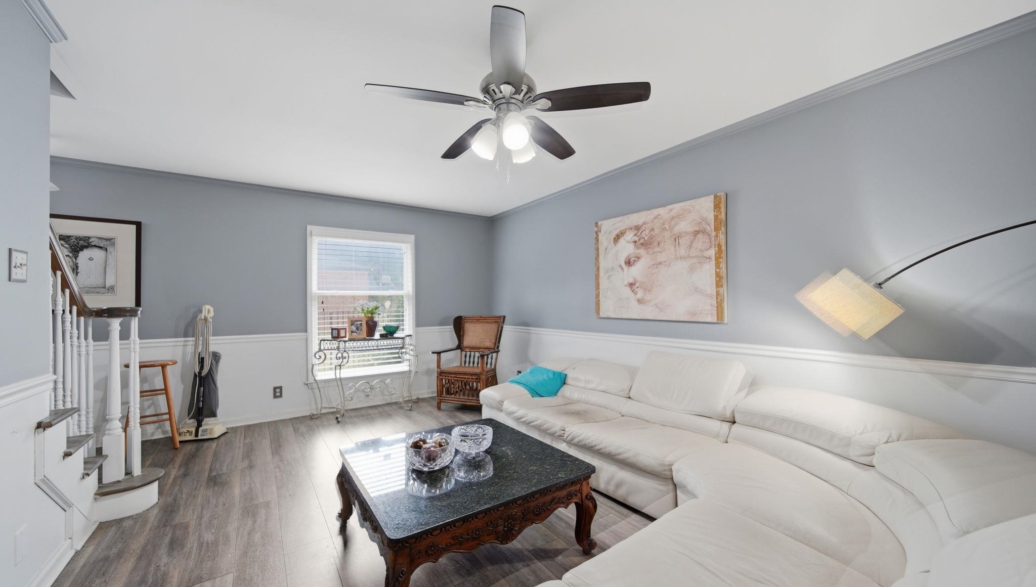 5866 Roxbury Drive, Unit 5866 Memphis, TN 38119 - Photo 3 of 20 Living area featuring wood-finish flooring, light gray walls, and white wainscoting