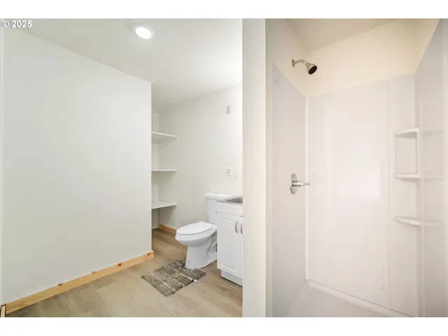 a bathroom with a toilet and a shower