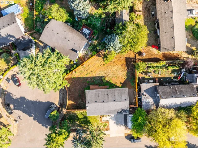 an aerial view of a house with a yard and garden