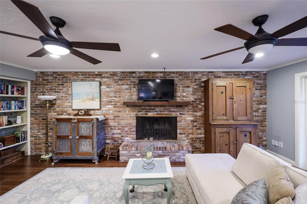 2006 Northwest 104th Way Gainesville, FL 32606 - Photo 15 of 71 a living room with furniture a ceiling fan and a fireplace