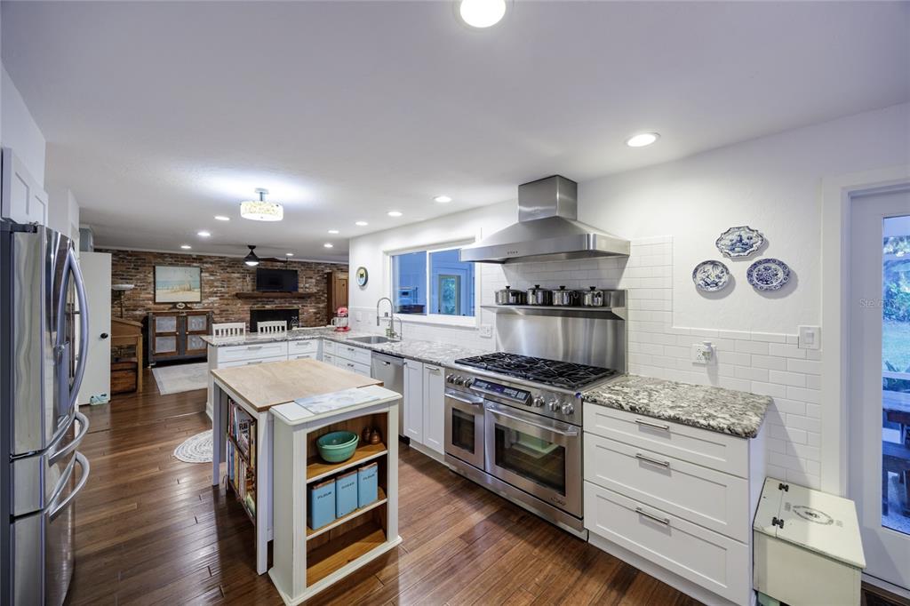 2006 Northwest 104th Way Gainesville, FL 32606 - Photo 21 of 71 a kitchen with stainless steel appliances granite countertop a stove and a refrigerator