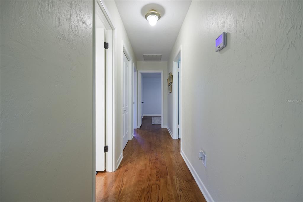 2006 Northwest 104th Way Gainesville, FL 32606 - Photo 48 of 71 a view of a hallway with wooden floor and closet