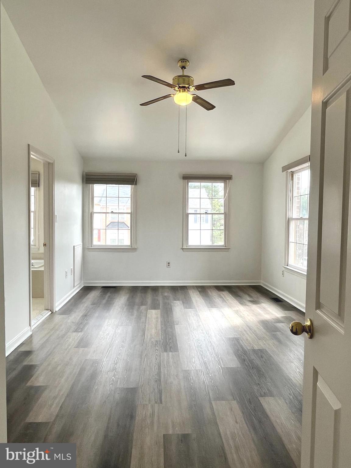 2034 Pinecroft Court Odenton, MD 21113 - Photo 12 of 31 a view of an empty room with wooden floor and a window
