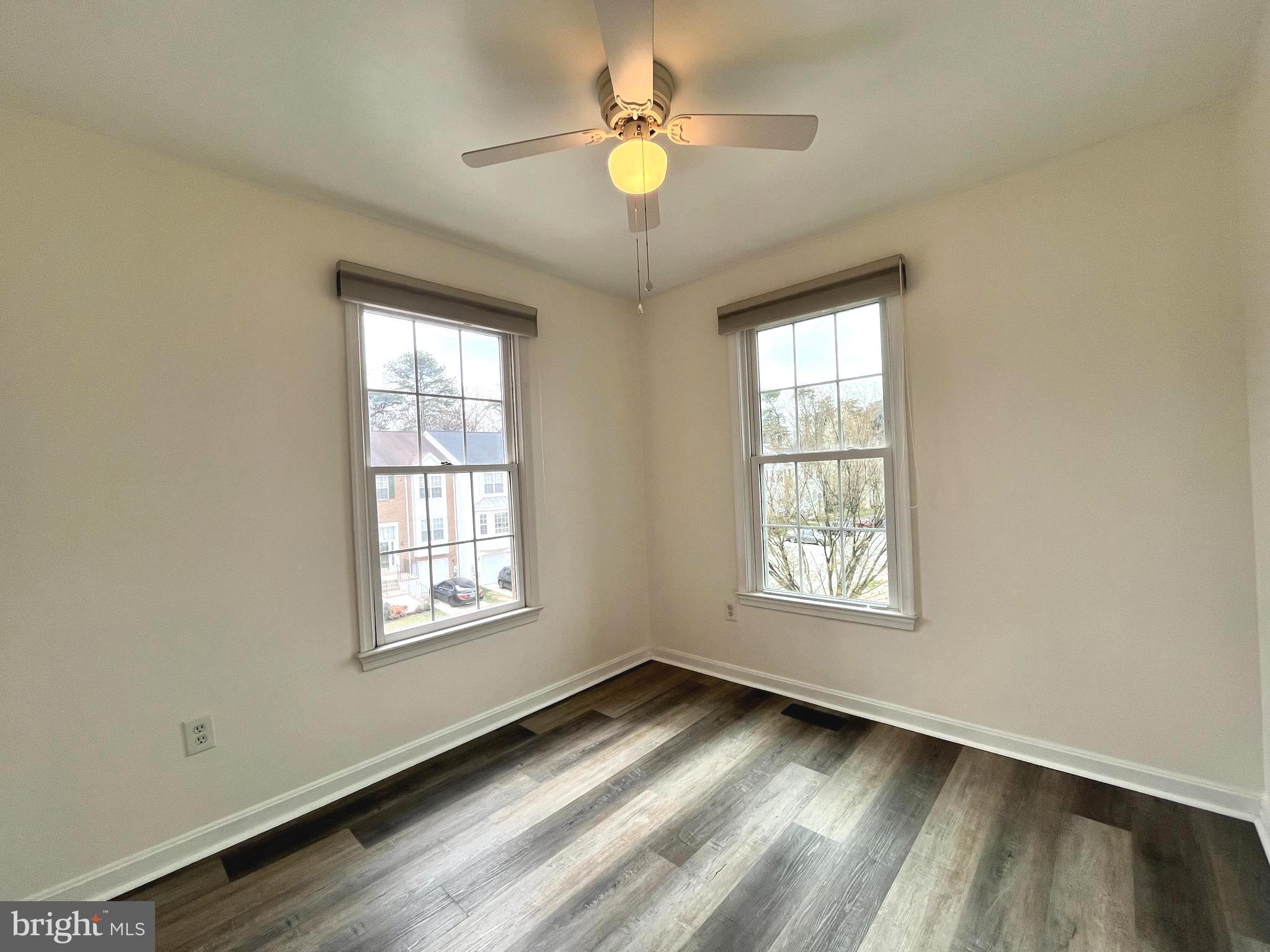 2034 Pinecroft Court Odenton, MD 21113 - Photo 17 of 31 a view of an empty room and window and chandelier fan