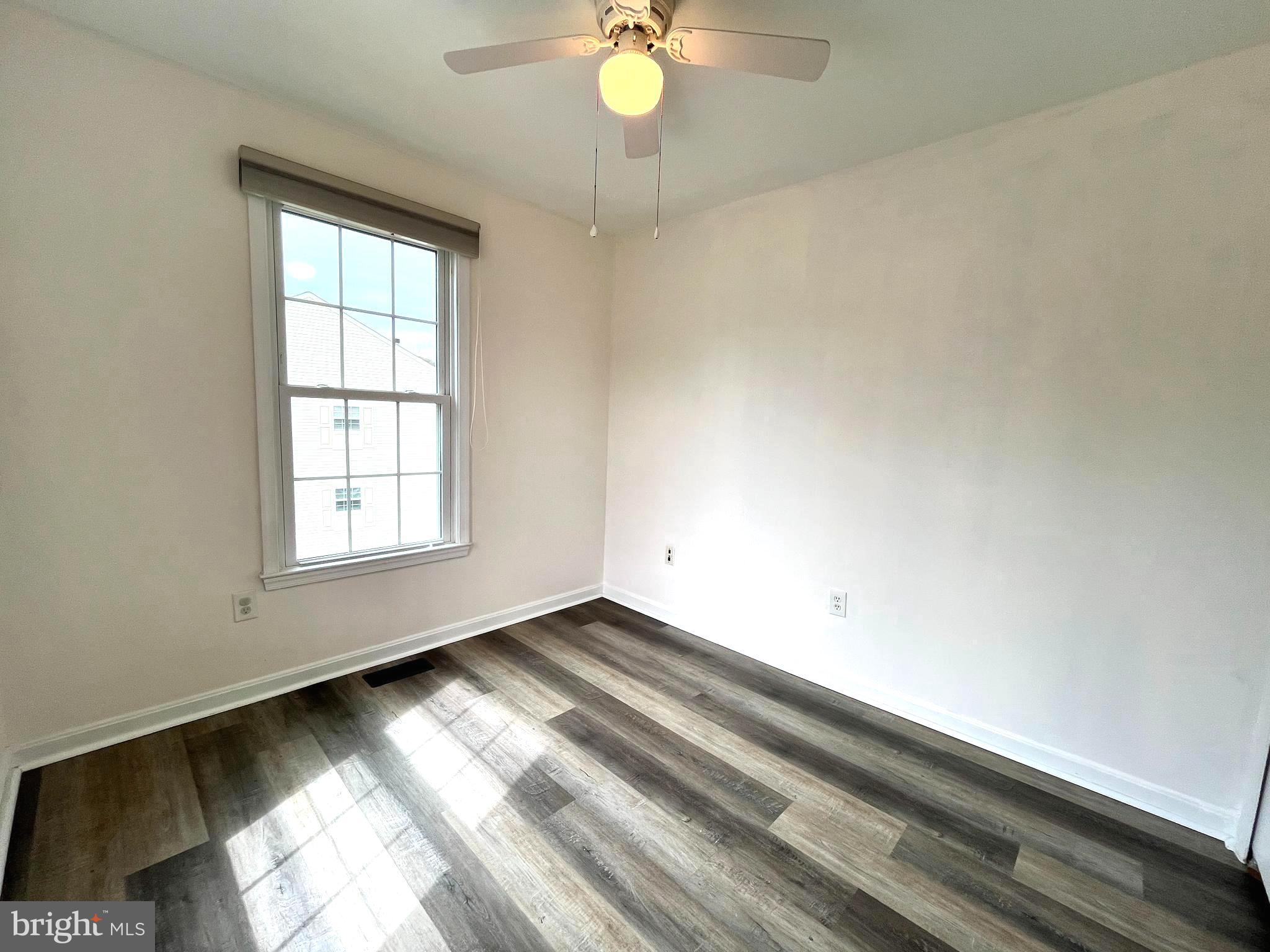 2034 Pinecroft Court Odenton, MD 21113 - Photo 18 of 31 an empty room with wooden floor and windows