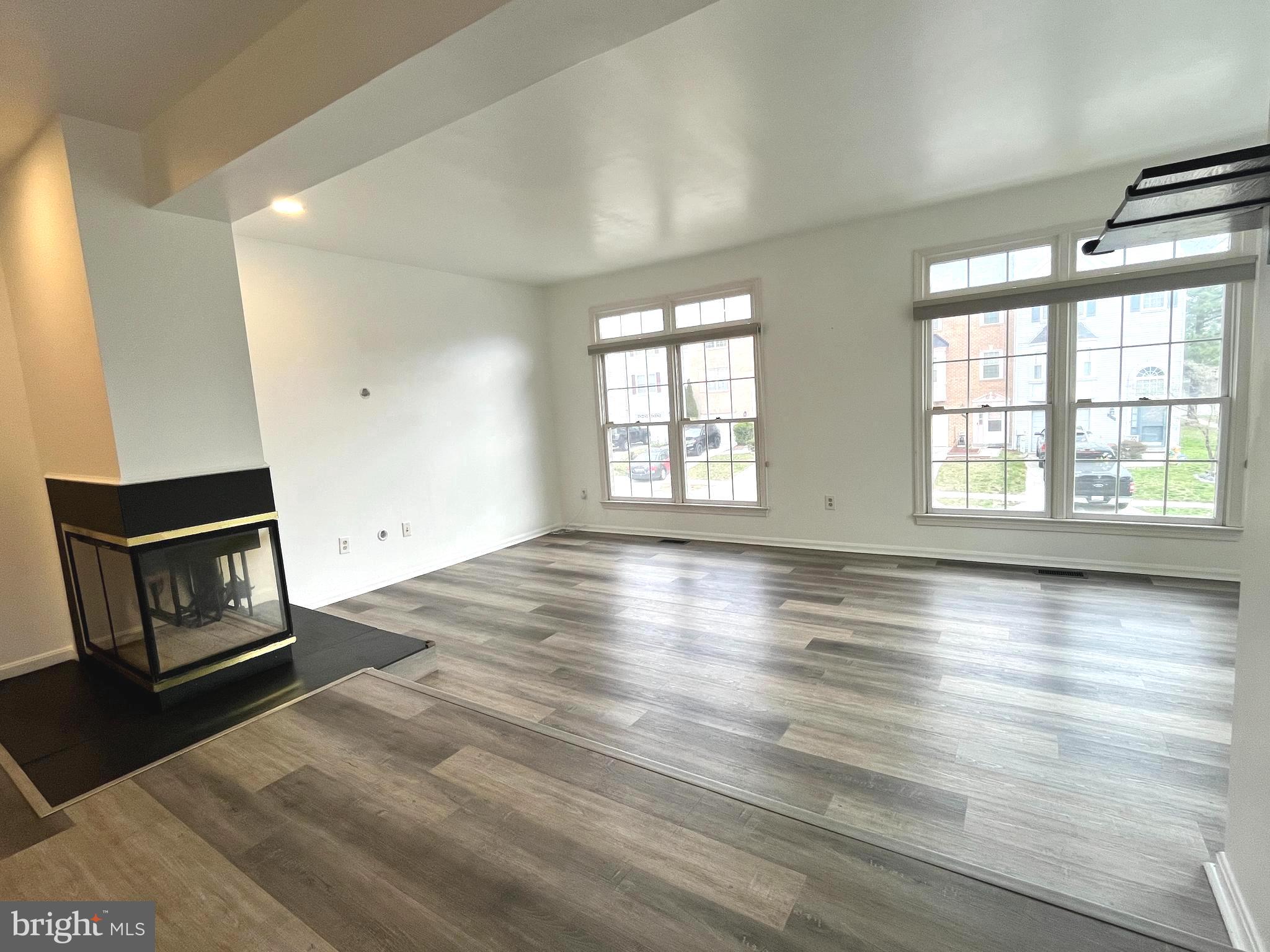2034 Pinecroft Court Odenton, MD 21113 - Photo 9 of 31 a view of an empty room with wooden floor and a window