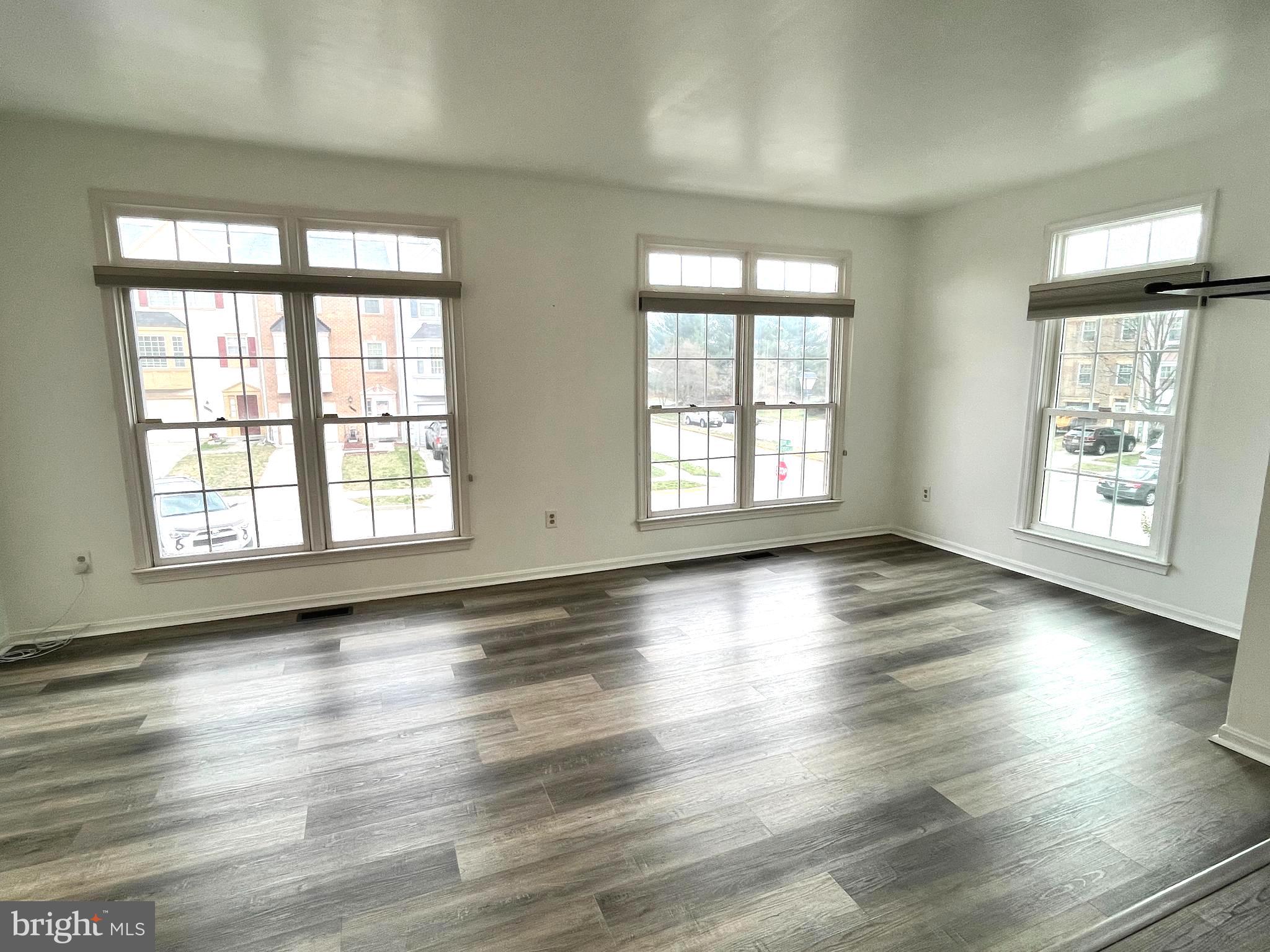 2034 Pinecroft Court Odenton, MD 21113 - Photo 10 of 31 an empty room with wooden floor and windows