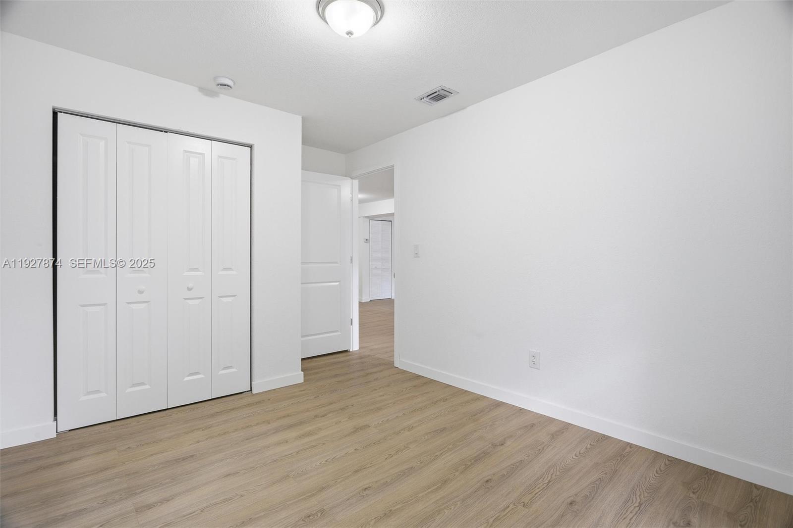 465 Northeast 165th Street, Unit 465 Miami, FL 33162 - Photo 11 of 15 a view of an empty room with wooden floor