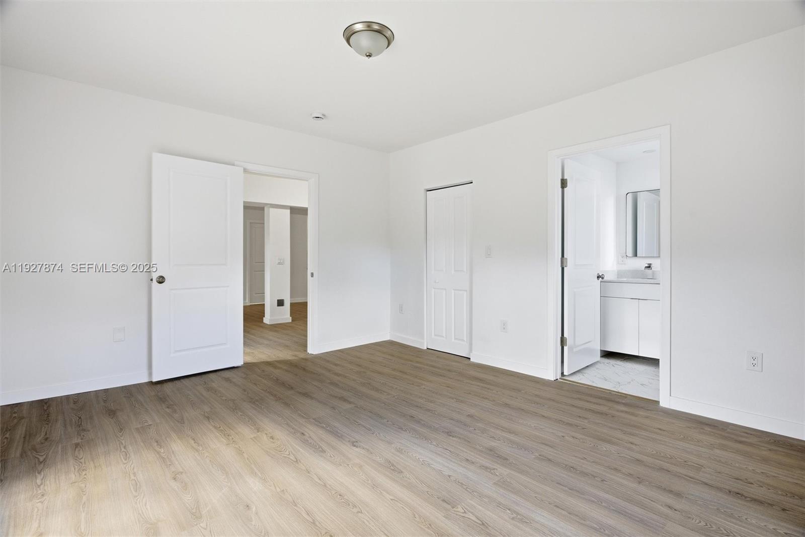 465 Northeast 165th Street, Unit 465 Miami, FL 33162 - Photo 12 of 15 a view of empty room with wooden floor