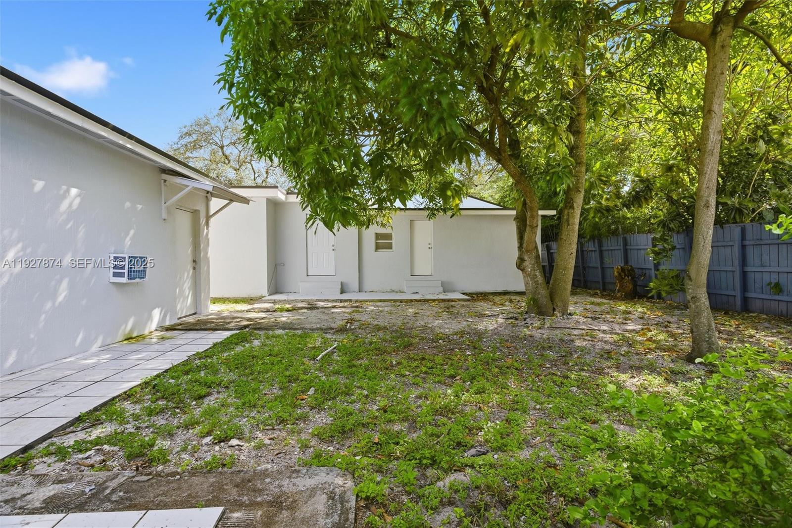 465 Northeast 165th Street, Unit 465 Miami, FL 33162 - Photo 15 of 15 a backyard of a house with table and chairs