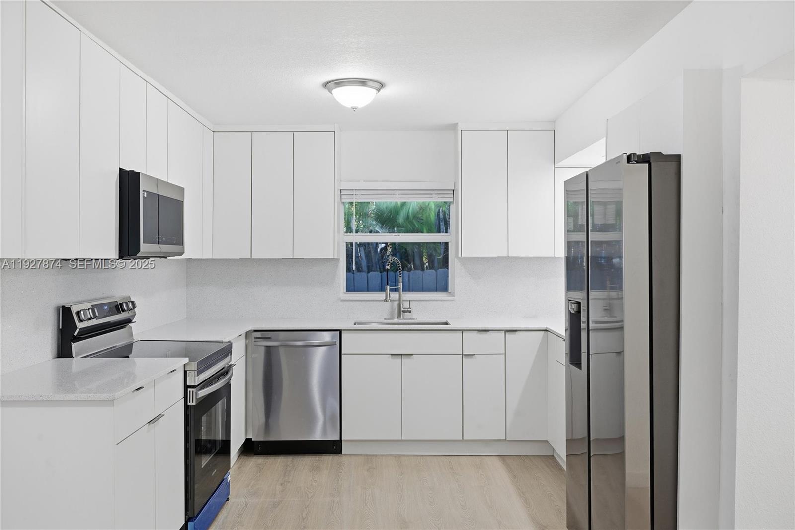 465 Northeast 165th Street, Unit 465 Miami, FL 33162 - Photo 4 of 15 a kitchen with a sink stove and refrigerator