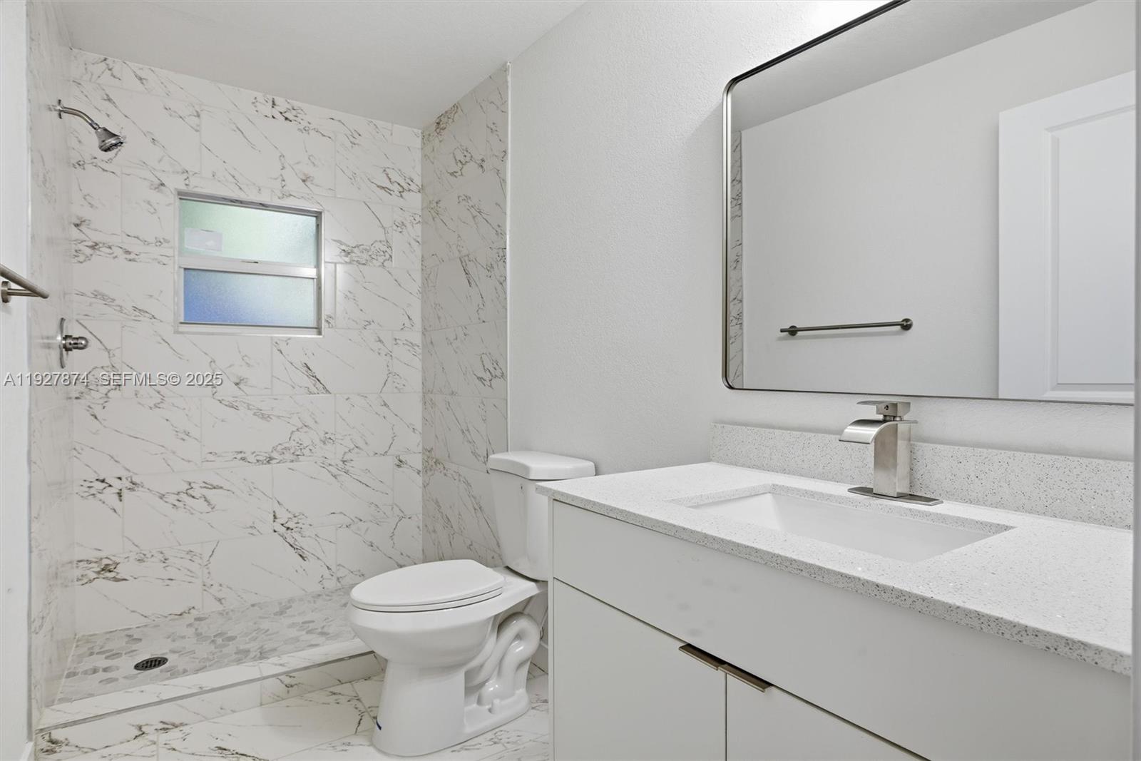 465 Northeast 165th Street, Unit 465 Miami, FL 33162 - Photo 7 of 15 a bathroom with a sink a toilet and shower