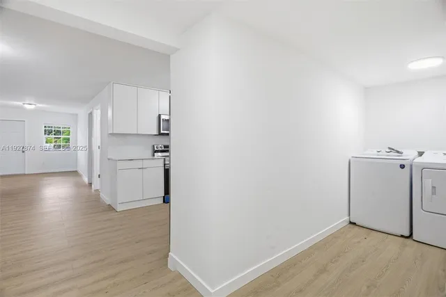 a view of a kitchen with wooden floor and a sink