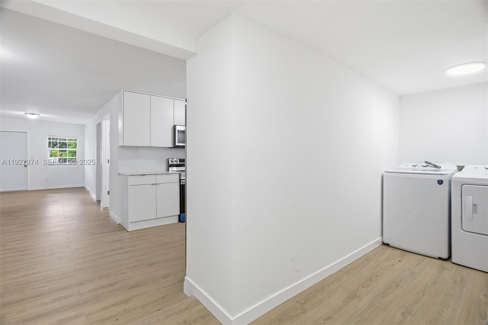 465 Northeast 165th Street, Unit 465 Miami, FL 33162 - Photo 9 of 15 a view of a kitchen with wooden floor and a sink