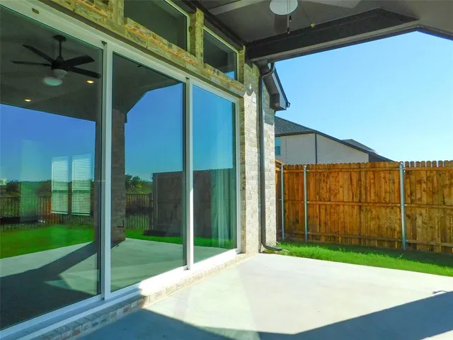 a view of a house with a yard and sitting area