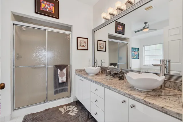 a spacious bathroom with a granite countertop sink and a mirror