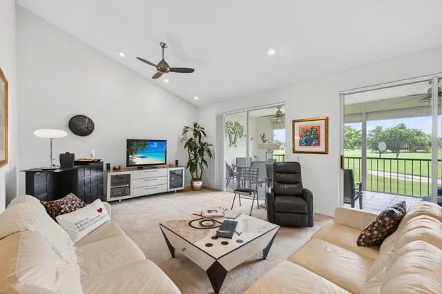 a living room with furniture and a floor to ceiling window