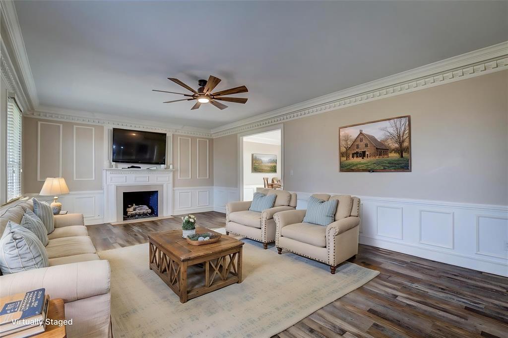 7359 Highway 154 Sulphur Springs, TX 75482 - Photo 10 of 40 Living room off of entry has fireplace, dentil molding, wainscoting, 6-inch baseboards- the quality is unmatched
