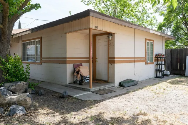 a backyard of a house with barbeque oven