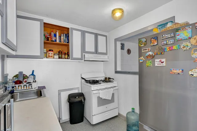 a kitchen with stainless steel appliances a refrigerator and a stove top oven