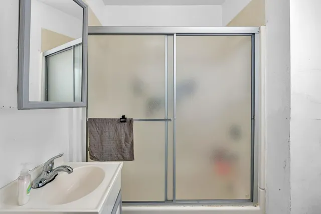 a bathroom with a sink and shower