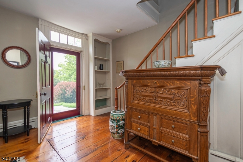 449 Stamets Road Milford, NJ 08848 - Photo 7 of 44 a view of an entryway with wooden floor windows and a fireplace