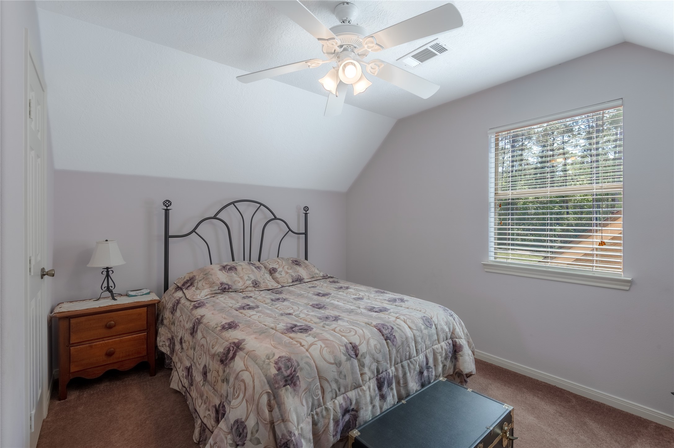 15 Lake Side Trinity, TX 75862 - Photo 19 of 33 a bedroom with a bed and a chandelier