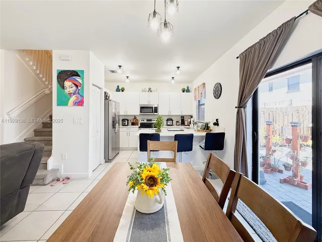a view of a dining room with furniture and a flat screen tv