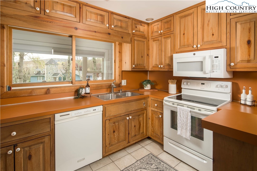 109 Old Field Road Beech Mountain, NC 28604 - Photo 18 of 50 a kitchen with a sink stove and cabinets