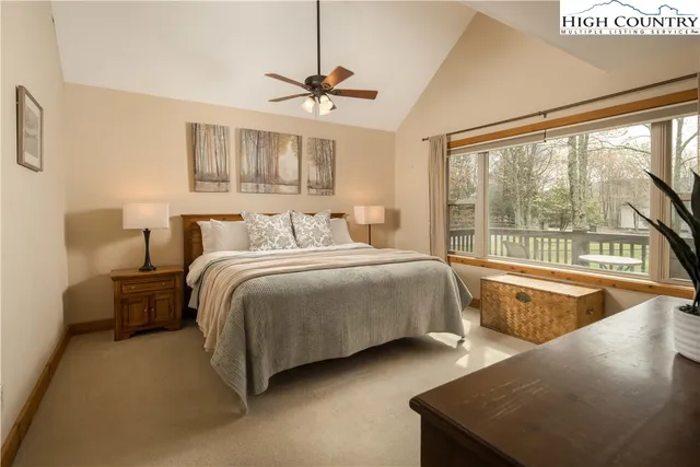 a bedroom with two large bed and a large window