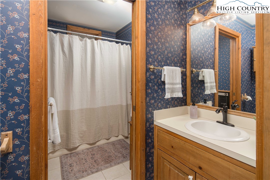 109 Old Field Road Beech Mountain, NC 28604 - Photo 26 of 50 a bathroom with a sink and a mirror