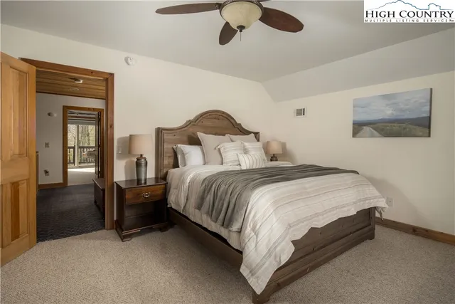 a bedroom with a bed and flat screen tv