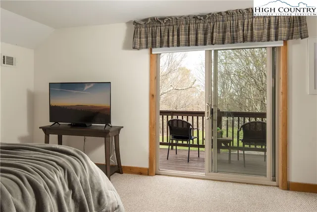 a room with furniture a rug and white walls
