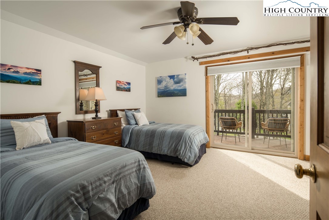 109 Old Field Road Beech Mountain, NC 28604 - Photo 32 of 50 a bedroom with two large bed and a large window