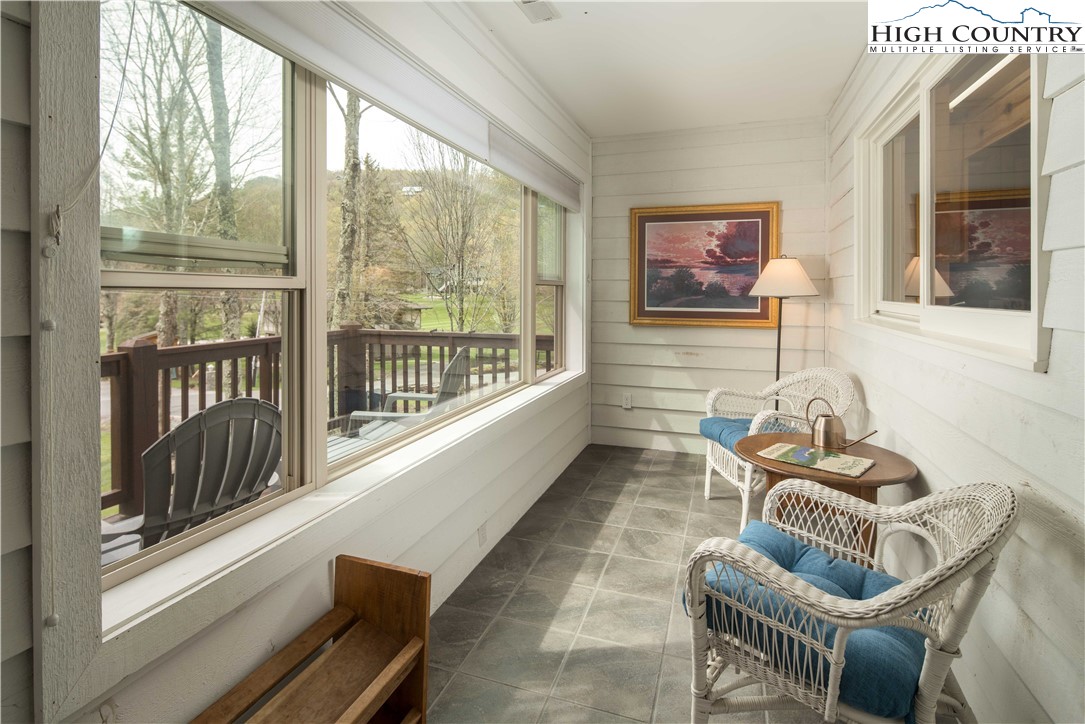 109 Old Field Road Beech Mountain, NC 28604 - Photo 10 of 50 a living room with furniture and floor to ceiling windows