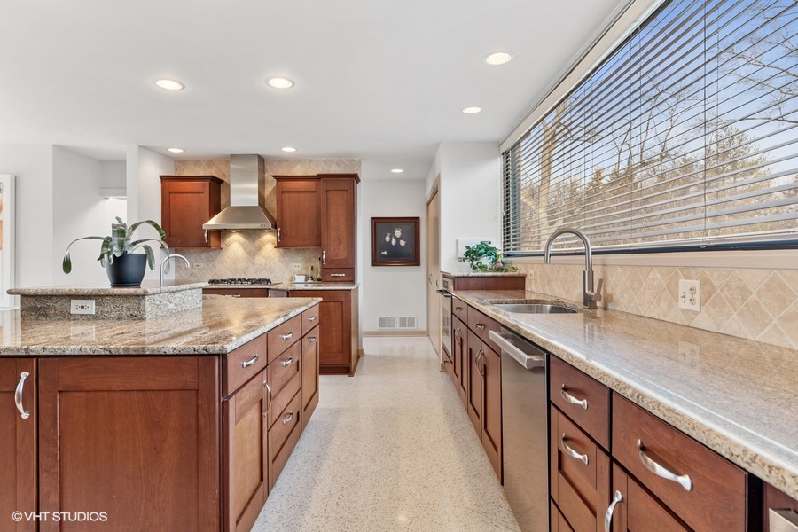 1700 Ridge Road Highland Park, IL 60035 - Photo 28 of 56 a kitchen with stainless steel appliances granite countertop sink stove and cabinets