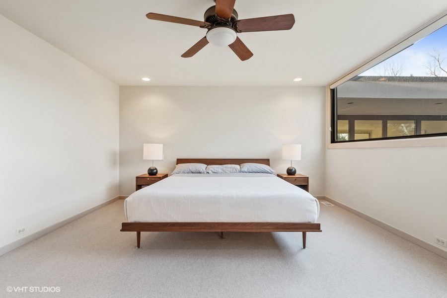 1700 Ridge Road Highland Park, IL 60035 - Photo 33 of 56 a bedroom with a bed and a chandelier