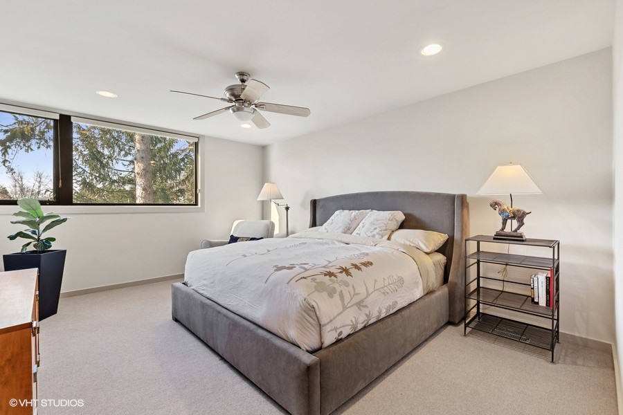 1700 Ridge Road Highland Park, IL 60035 - Photo 38 of 56 a spacious bedroom with a bed and a chandelier