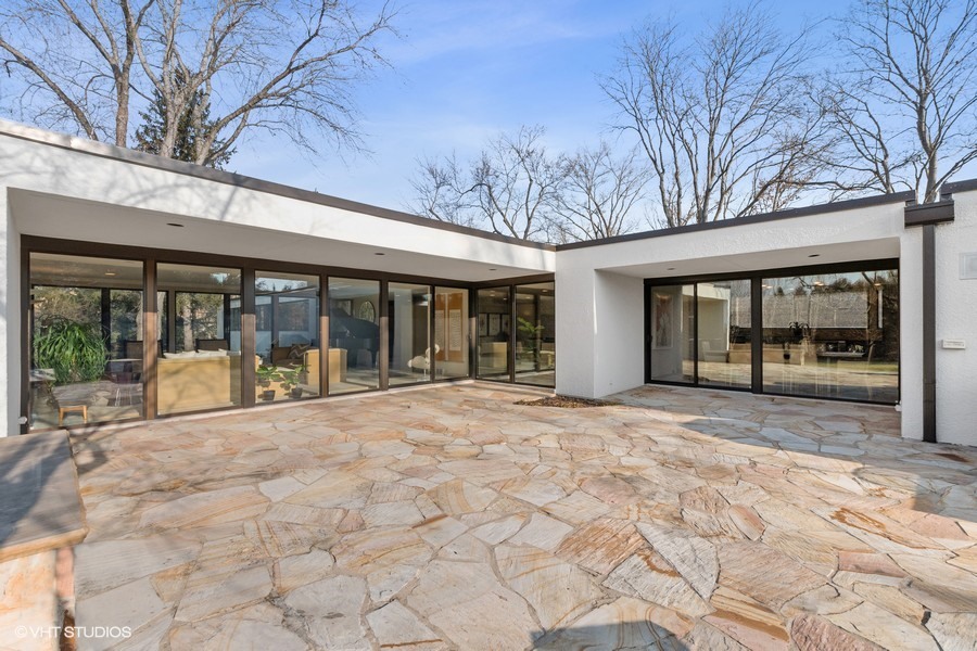 1700 Ridge Road Highland Park, IL 60035 - Photo 7 of 56 a view of a house with large windows and a small yard