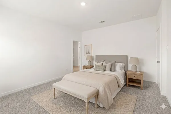 a bedroom with a bed and a chair