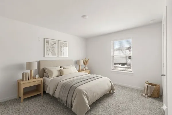 a bedroom with bed and a window