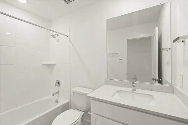 a bathroom with a sink toilet vanity and shower
