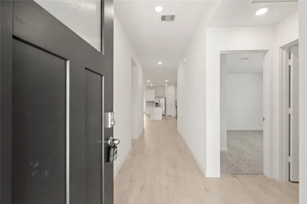 a view of a hallway with a bathroom