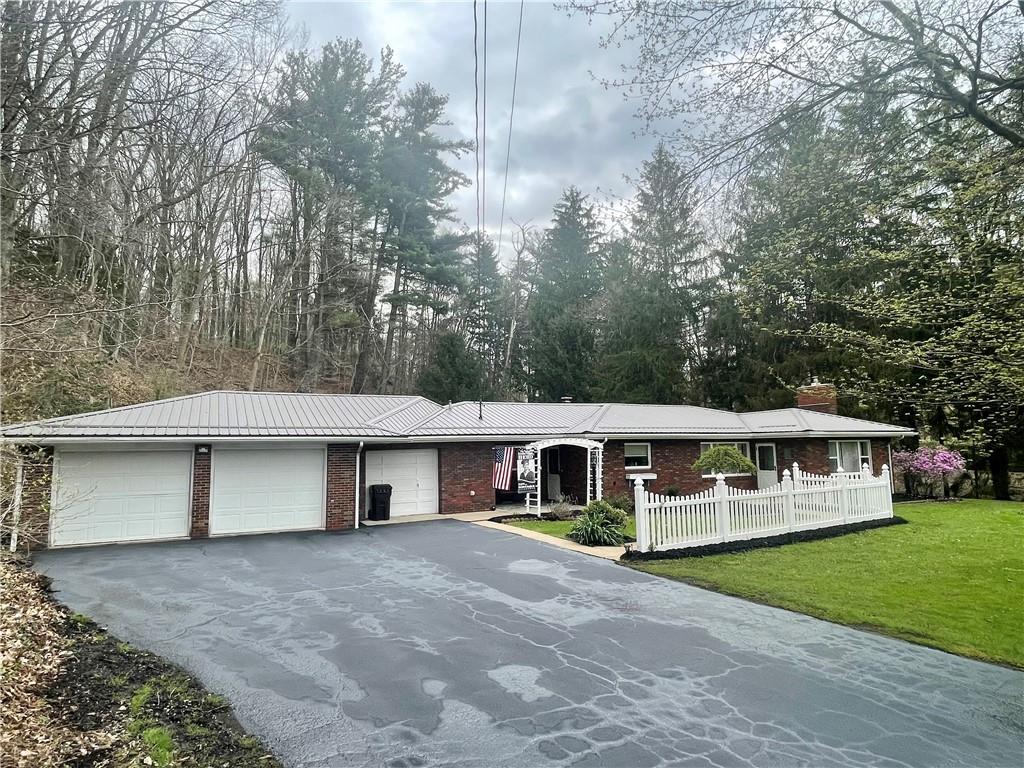 2774 Pulaski Road New Castle, PA 16105 - Photo 1 of 19 a front view of a house with yard garage and green space