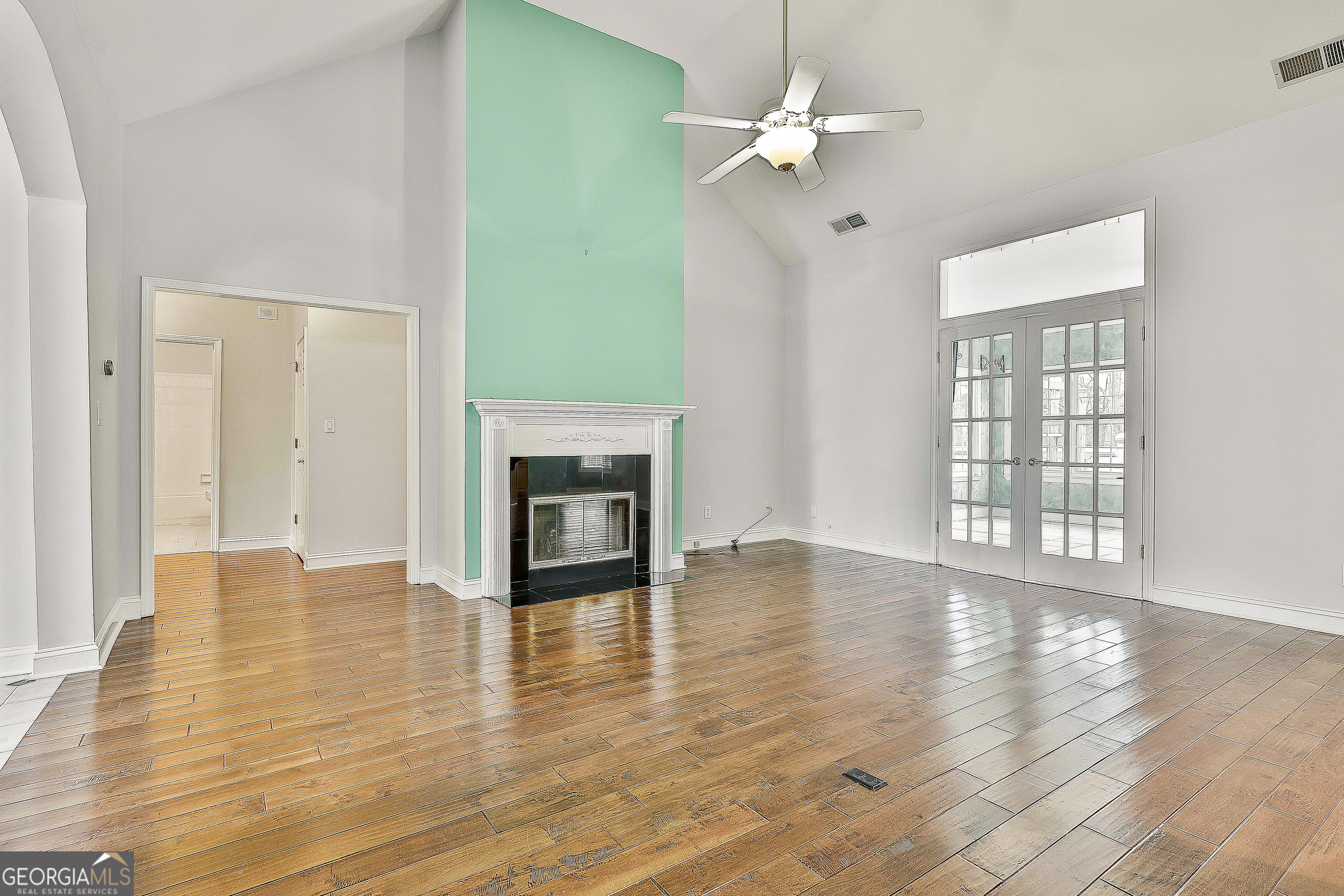 207 Prestwick Way North Stockbridge, GA 30281 - Photo 11 of 44 an empty room with wooden floor fan and windows