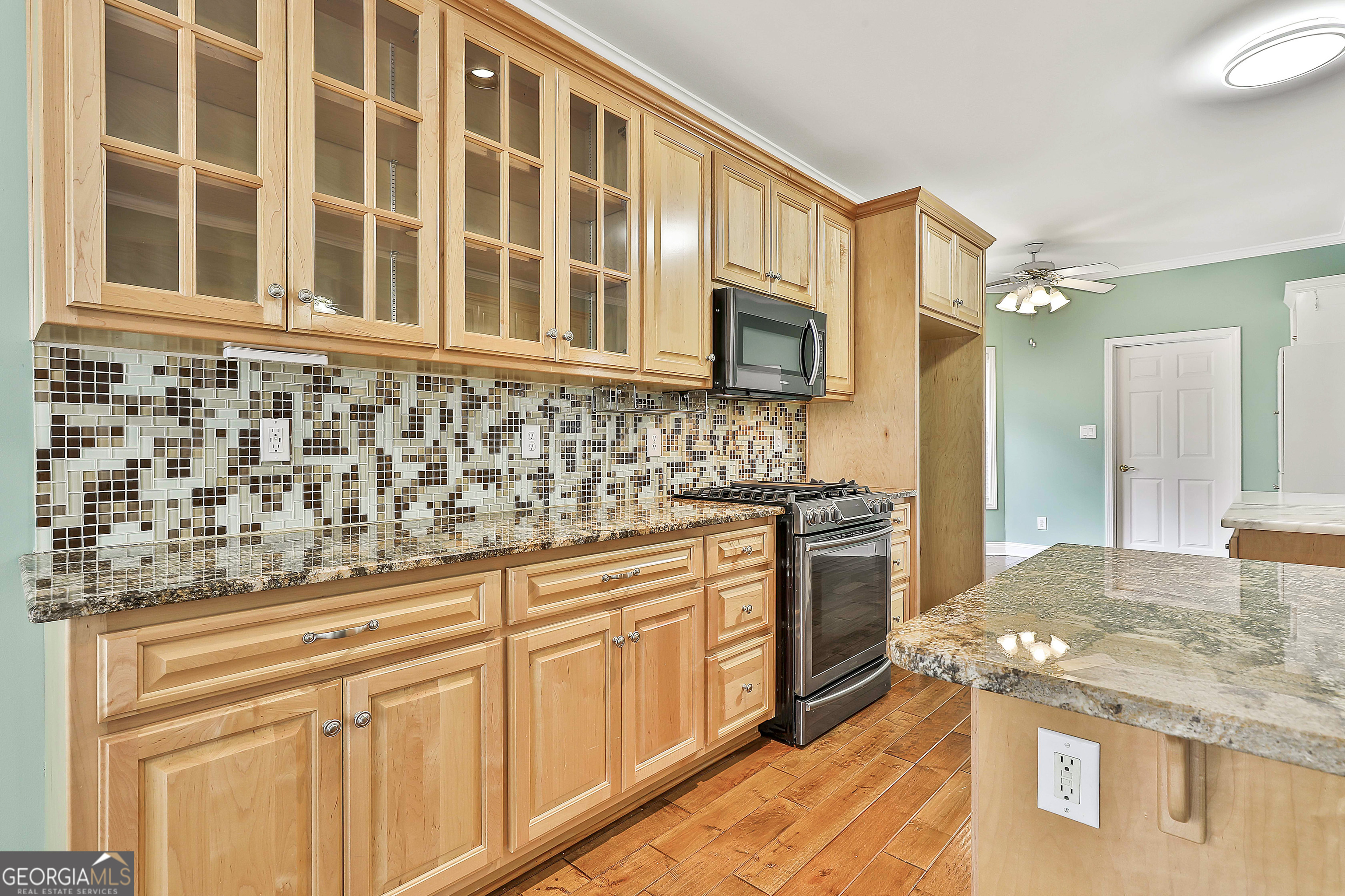 207 Prestwick Way North Stockbridge, GA 30281 - Photo 18 of 44 a kitchen with stainless steel appliances granite countertop a stove and a sink