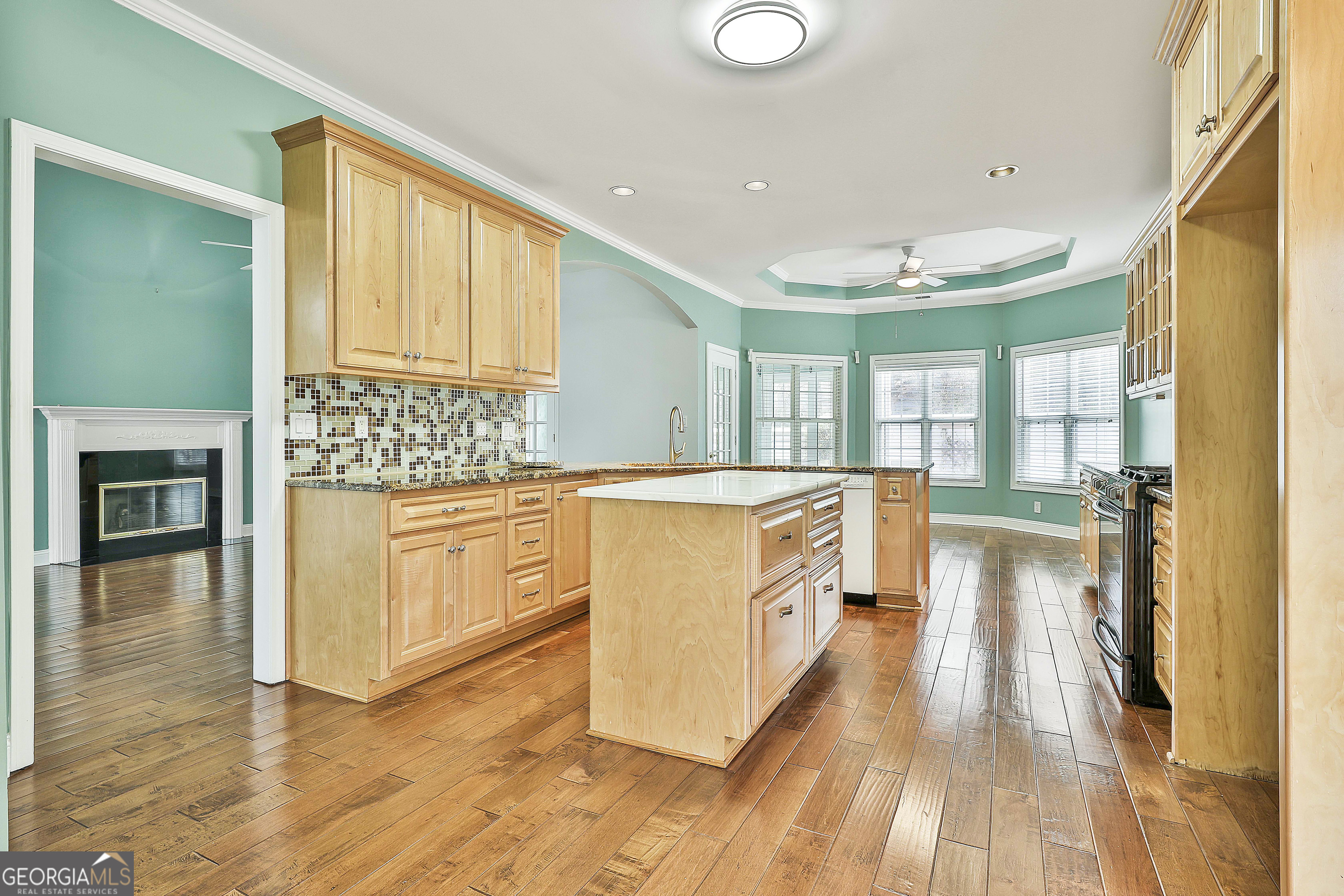 207 Prestwick Way North Stockbridge, GA 30281 - Photo 22 of 44 a kitchen with stainless steel appliances granite countertop a stove and a wooden floors