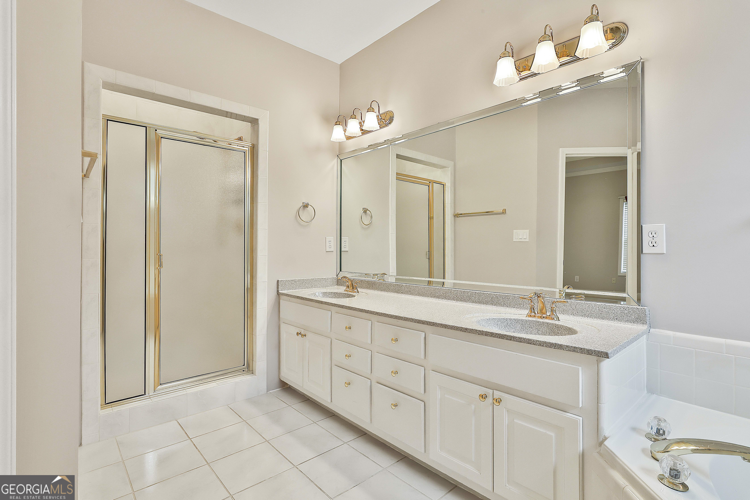 207 Prestwick Way North Stockbridge, GA 30281 - Photo 28 of 44 a bathroom with a double vanity sink and a mirror